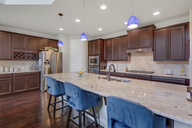 4458 Hartebeest Trl, Frisco, TX 75034 - kitchen with stainless steel appliances, a sink, a kitchen breakfast bar, tasteful backsplash, and recessed lighting