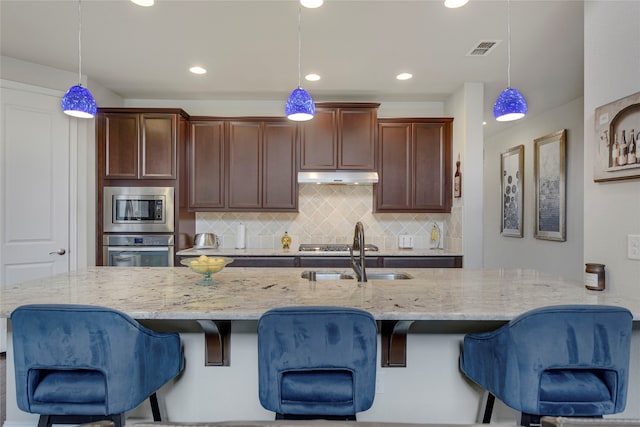 4458 Hartebeest Trl, Frisco, TX 75034 - kitchen featuring appliances with stainless steel finishes, a sink, light stone countertops, backsplash, and recessed lighting