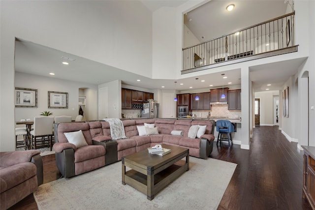 4458 Hartebeest Trl, Frisco, TX 75034 - living room with dark wood finished floors, recessed lighting, a high ceiling, and baseboards