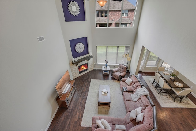 4458 Hartebeest Trl, Frisco, TX 75034 - living area with a high ceiling, a stone fireplace, wood finished floors, and baseboards