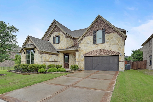 4458 Hartebeest Trl, Frisco, TX 75034 - french country style house featuring stone siding, concrete driveway, a garage, and cooling unit