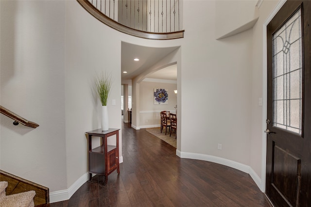 4458 Hartebeest Trl, Frisco, TX 75034 - entryway featuring arched walkways, wood finished floors, baseboards, stairs, and a high ceiling