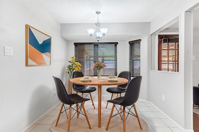 5504 Shady Meadow St, North Richland Hills, TX 76180 - dining room with light tile patterned floors, a chandelier, and baseboards