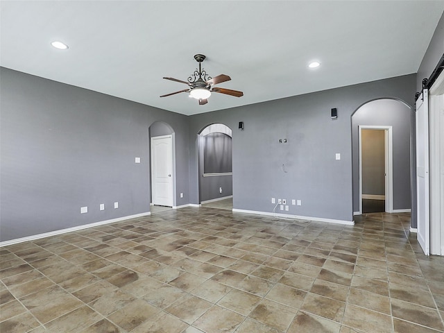 14812 Lone Spring Dr, Little Elm, TX 75068 - unfurnished room with arched walkways, ceiling fan, a barn door, baseboards, and recessed lighting