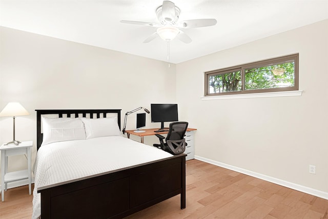 bedroom featuring light wood-style flooring, baseboards, and ceiling fan