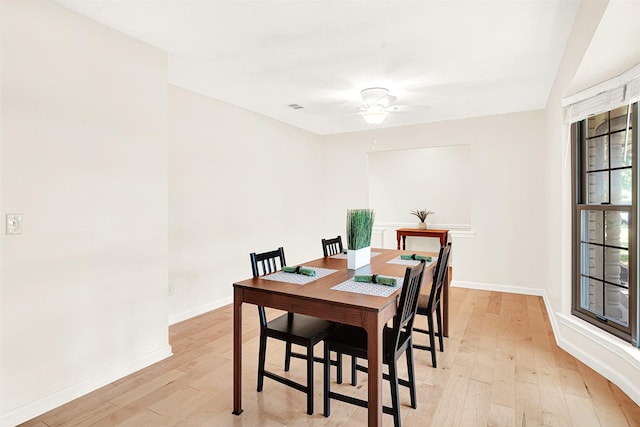 dining room with light wood-style flooring, baseboards, and ceiling fan