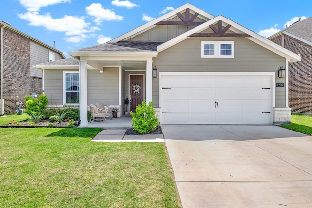 view of front facade featuring driveway, a front yard, board and batten siding, and an attached garage