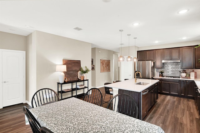 dining area with dark wood-style flooring, baseboards, and recessed lighting