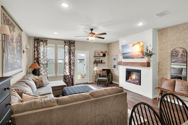 living room with wood finished floors, a large fireplace, a ceiling fan, recessed lighting, and baseboards