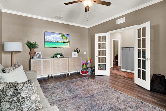 living area with french doors, wood finished floors, ornamental molding, ceiling fan, and baseboards