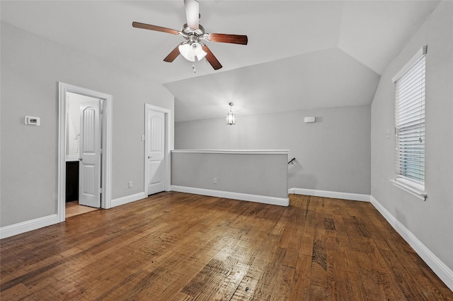 bonus room featuring ceiling fan, vaulted ceiling, plenty of natural light, wood finished floors, and baseboards