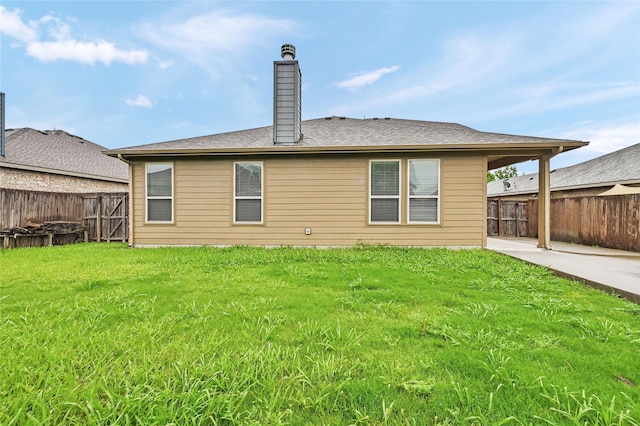 rear view of property featuring a chimney and a patio