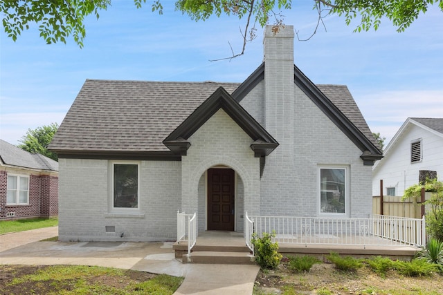 2735 S Jennings Ave, Fort Worth, TX 76110 - french country inspired facade with roof with shingles, brick siding, and a chimney