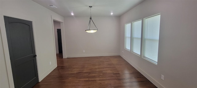 unfurnished dining area featuring baseboards, dark wood-style floors, and recessed lighting