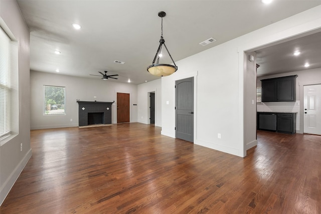 2735 S Jennings Ave, Fort Worth, TX 76110 - unfurnished living room with a ceiling fan, dark wood-style floors, baseboards, recessed lighting, and a fireplace
