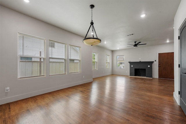 2735 S Jennings Ave, Fort Worth, TX 76110 - unfurnished living room featuring a ceiling fan, baseboards, a brick fireplace, recessed lighting, and wood finished floors