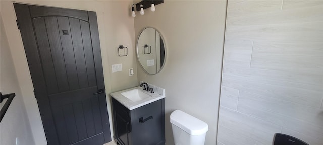 bathroom featuring toilet and vanity