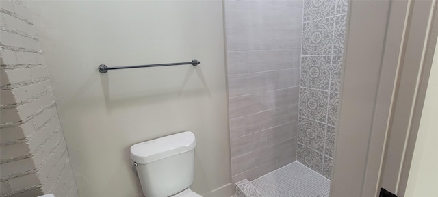 bathroom with a stall shower and toilet