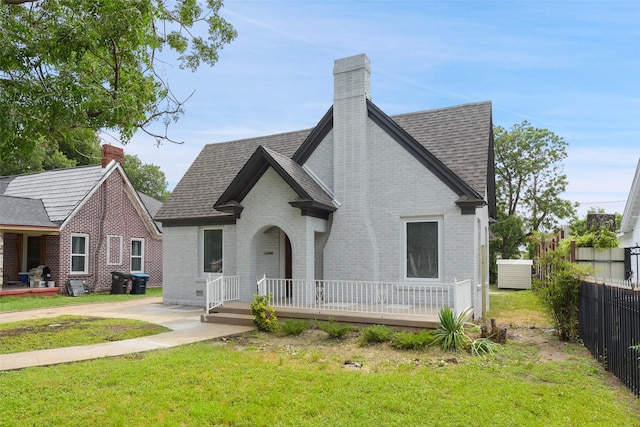 2735 S Jennings Ave, Fort Worth, TX 76110 - view of front of property with a chimney, brick siding, and a shingled roof