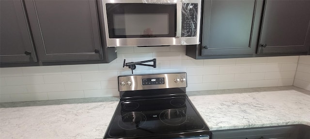 kitchen featuring appliances with stainless steel finishes and tasteful backsplash