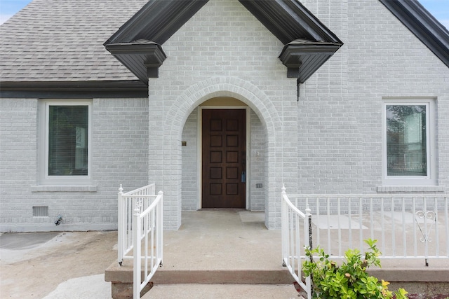 2735 S Jennings Ave, Fort Worth, TX 76110 - view of exterior entry with brick siding and a shingled roof
