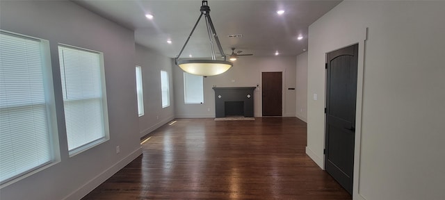 unfurnished living room featuring a fireplace with flush hearth, dark wood-style floors, baseboards, ceiling fan, and recessed lighting