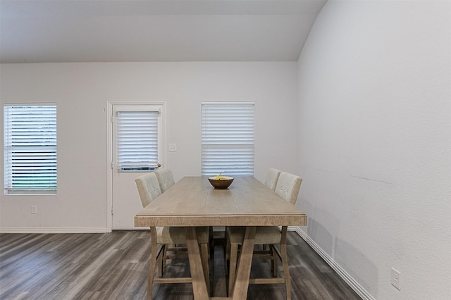dining space featuring dark wood-style flooring and baseboards