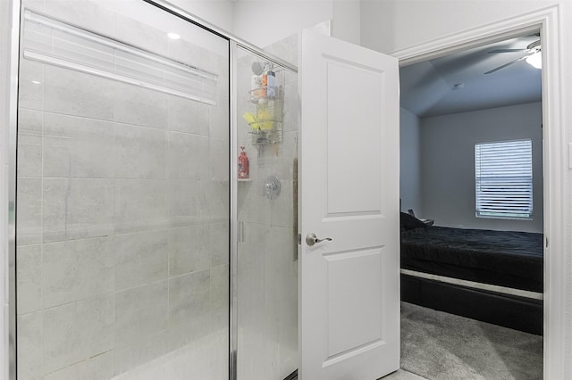 ensuite bathroom with a stall shower and ceiling fan