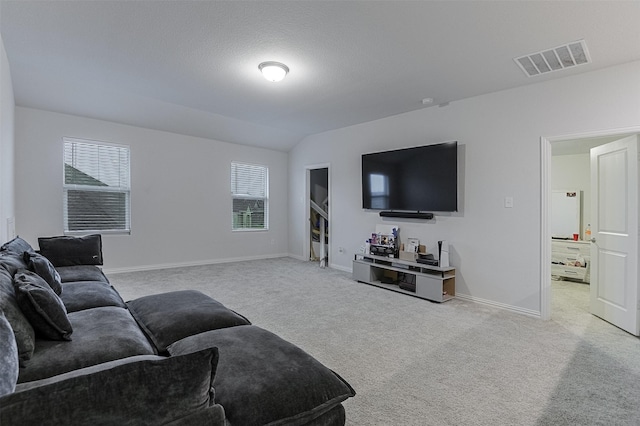 carpeted living room featuring baseboards