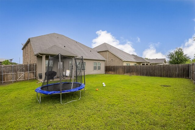 back of house featuring a trampoline