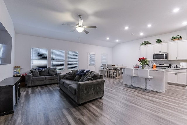 living area featuring light wood-style floors, recessed lighting, and ceiling fan