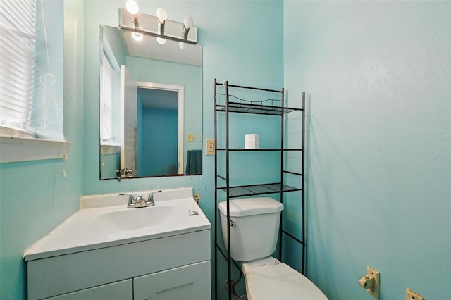 bathroom featuring toilet and vanity