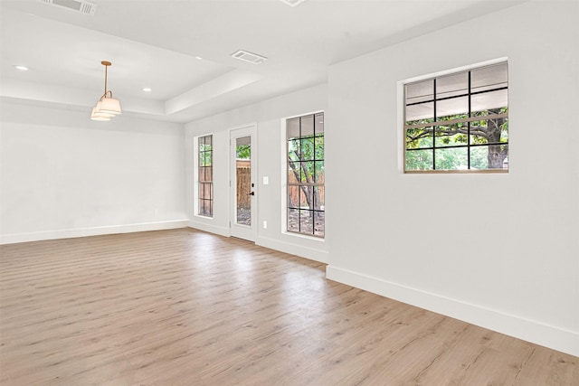 303 Randy Lee Ln, Mckinney, TX 75071 - spare room with light wood-style floors, baseboards, a raised ceiling, and recessed lighting