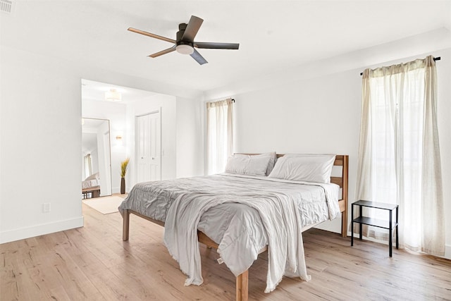 303 Randy Lee Ln, Mckinney, TX 75071 - bedroom featuring multiple windows, light wood finished floors, and a ceiling fan