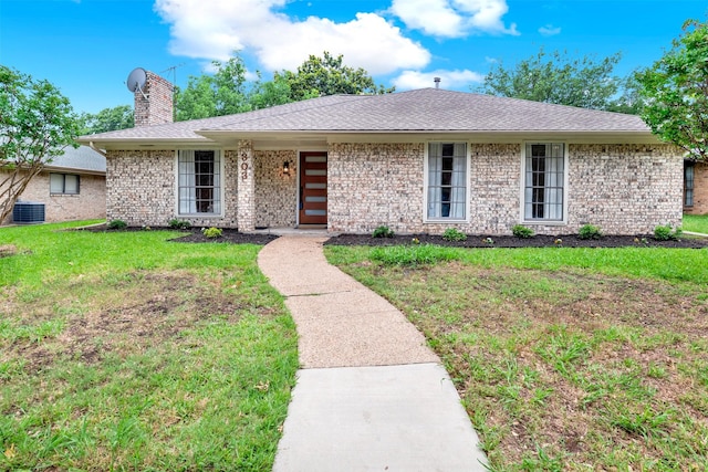 303 Randy Lee Ln, Mckinney, TX 75071 - view of front facade with a chimney, a front lawn, brick siding, and central AC