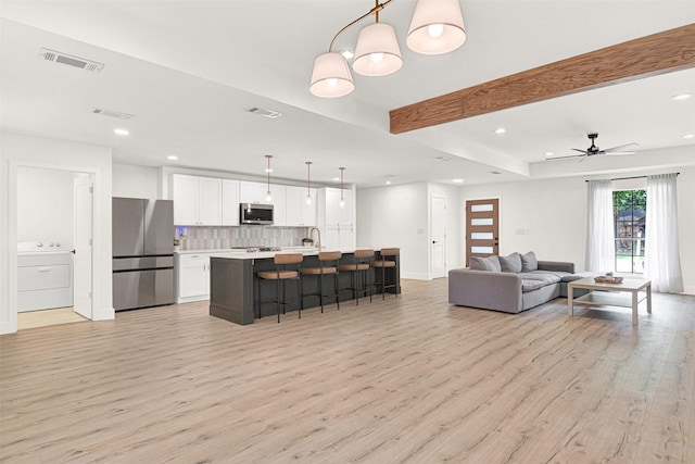 303 Randy Lee Ln, Mckinney, TX 75071 - living area with washer / clothes dryer, light wood finished floors, recessed lighting, beamed ceiling, and baseboards
