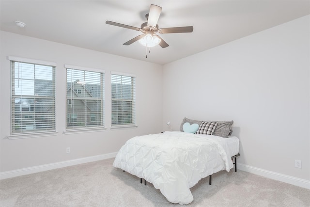 bedroom featuring carpet floors, baseboards, and a ceiling fan