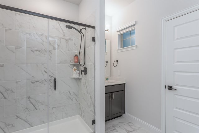 full bathroom with marble finish flooring, a stall shower, vanity, and baseboards