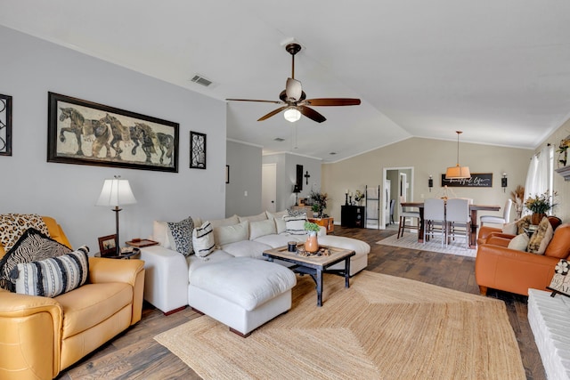living room with dark wood-style floors, a ceiling fan, and lofted ceiling