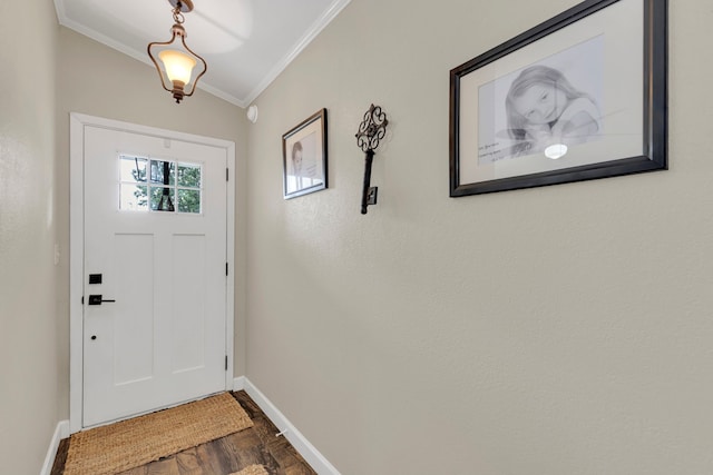 doorway with ornamental molding, baseboards, and dark wood-type flooring