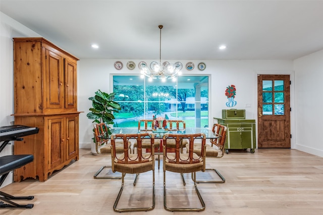 dining area with light wood finished floors, a chandelier, baseboards, and recessed lighting