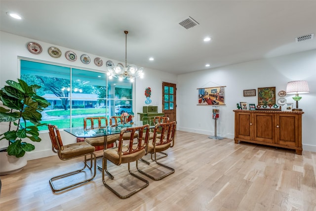 dining space with light wood-type flooring, recessed lighting, baseboards, and a chandelier