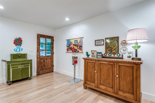foyer entrance featuring light wood-style flooring, recessed lighting, and baseboards