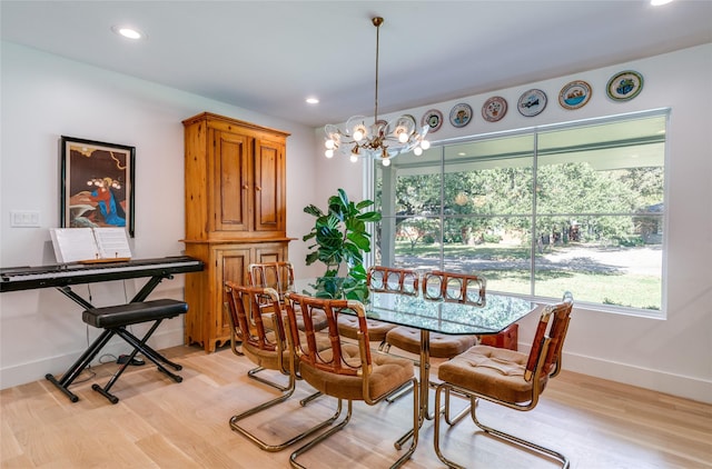 dining space featuring light wood-style flooring, a chandelier, recessed lighting, and baseboards