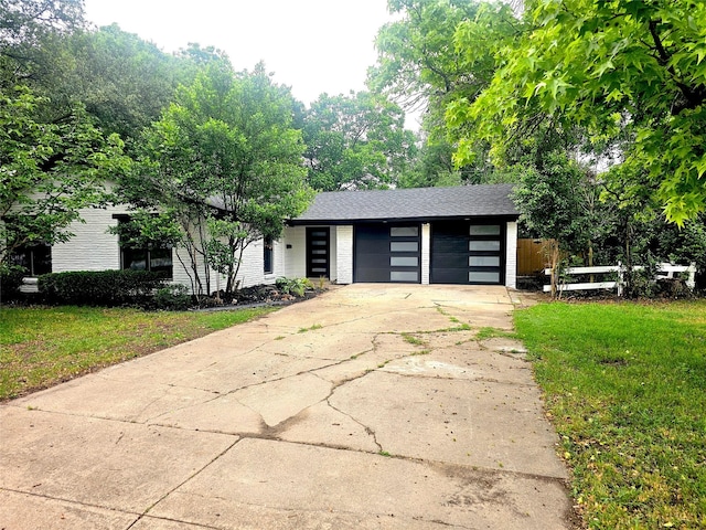 6604 Tabor St, North Richland Hills, TX 76180 - view of front of house with concrete driveway and a garage