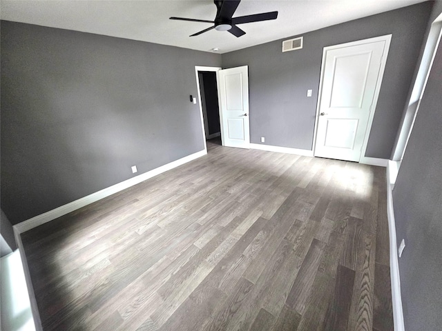 6604 Tabor St, North Richland Hills, TX 76180 - unfurnished bedroom featuring wood finished floors, baseboards, and ceiling fan