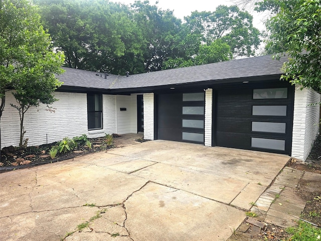 6604 Tabor St, North Richland Hills, TX 76180 - view of front of property with brick siding, driveway, roof with shingles, and an attached garage
