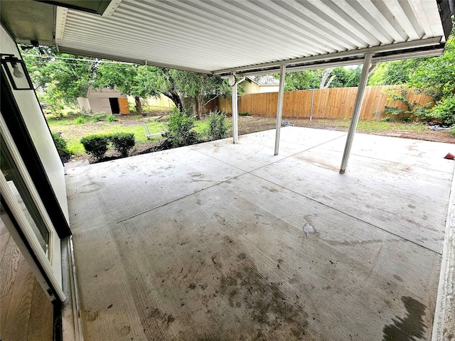 6604 Tabor St, North Richland Hills, TX 76180 - view of patio / terrace with a shed, a fenced backyard, and an outdoor structure