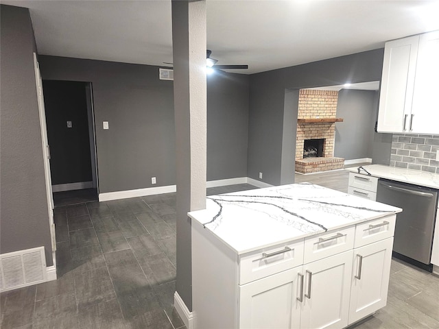 6604 Tabor St, North Richland Hills, TX 76180 - kitchen with stainless steel dishwasher, a ceiling fan, wood finished floors, light stone counters, and open floor plan