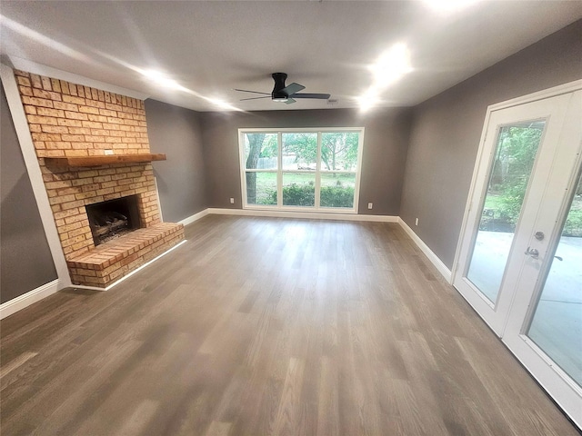 6604 Tabor St, North Richland Hills, TX 76180 - unfurnished living room featuring healthy amount of natural light, wood finished floors, a ceiling fan, and baseboards